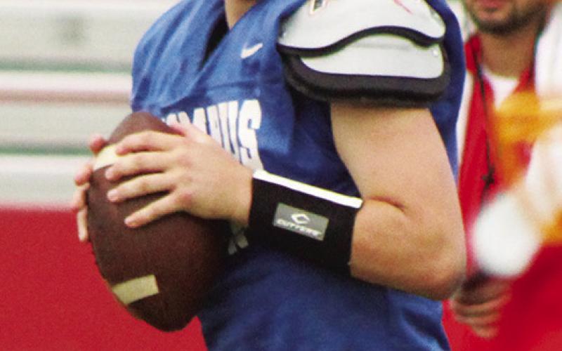 Sophomore quarterback, Jack Vilela, looks to throw during the Titan Football Lawn Chair Scrimmage, Saturday at Titan Stadium.