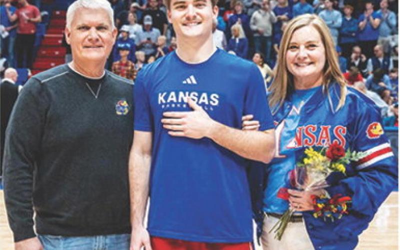 CUHS Graduate, Patrick Cassidy is joined by his parents, Jeff and Julie Cassidy during Senior Night at the Phog recognition at the final Kansas University Jayhawk home game. Patrick recently received 2025 Winter All-Academic Big 12 honors at KU. Courtesy photo.