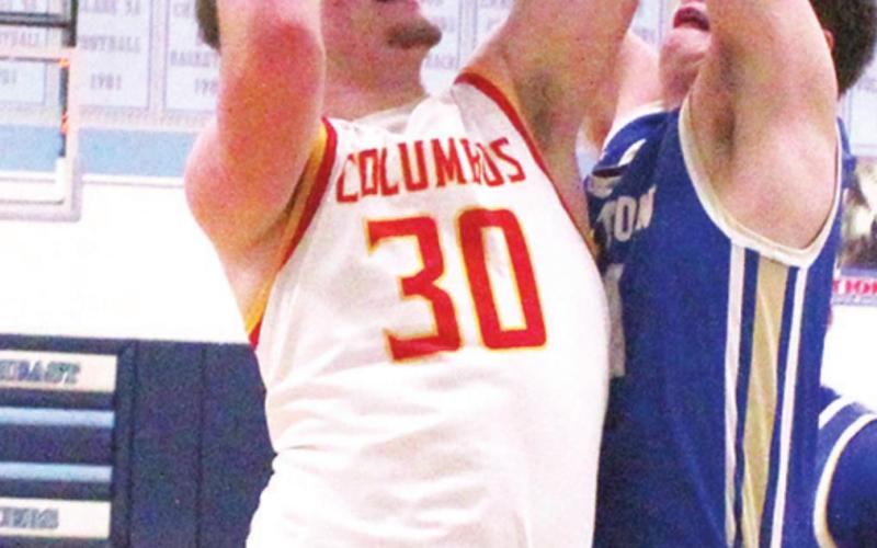 Brett Hamilton, Titan Junior, goes up for two of his team-high, 19 points, against Riverton defender, sophomore, Loch North. Brett hit a three pointer with 30 seconds to play in regulation to send the game into overtime and the eventual Columbus win, 62-59.