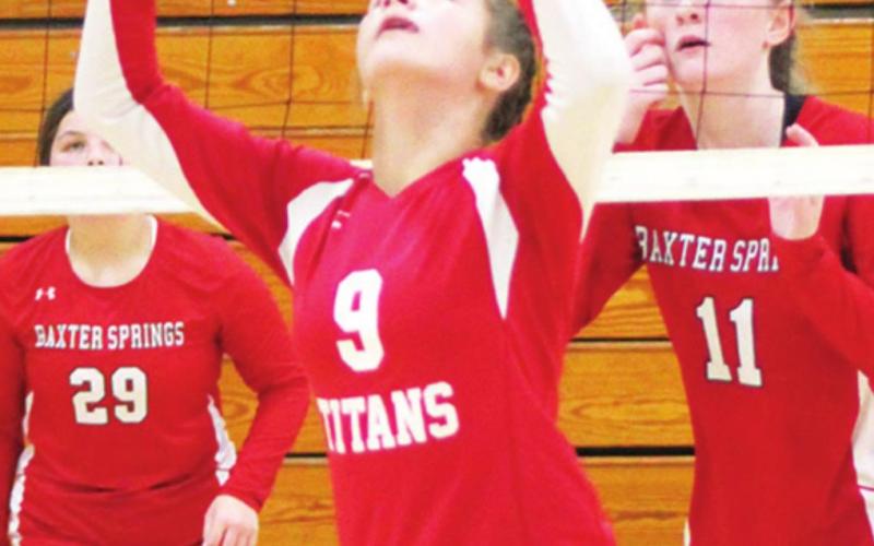 Lady Titan Ellie Helms sets the ball for her team mate in the September, eighth grade tournament at CUHS. Emerson Skye and Devyn Hopkins, Baxter Springs await the return.
