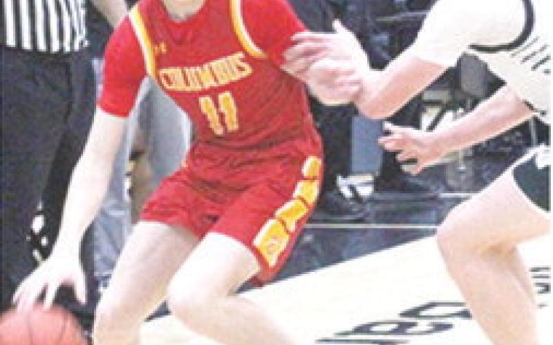 Titan Freshman, Jonas Stover, works toward the basket against Raider Junior, Jake Wegner, in the CNC loss at Frontenac, Monday. Stover led the Titans with eight points.
