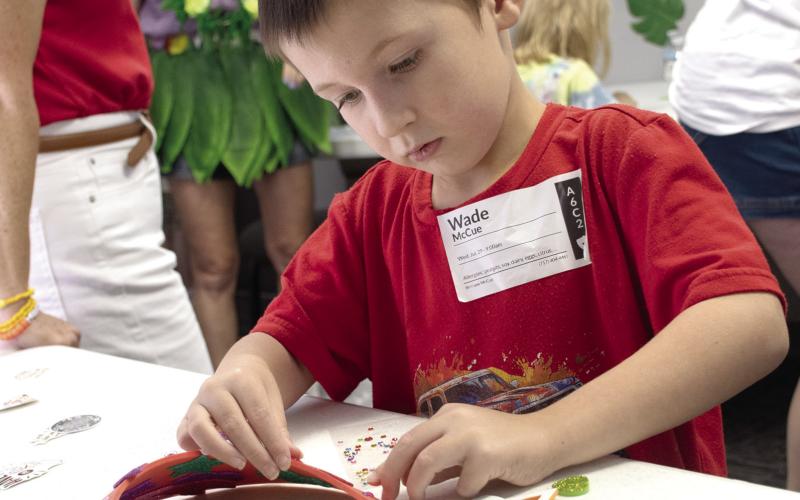 Crafts were a highly anticipated event as part of Connecting Point Church of the Nazarene’s first VBS held the week of July 27. Wade McCue of rural Columbus works to decorate his sun shade.