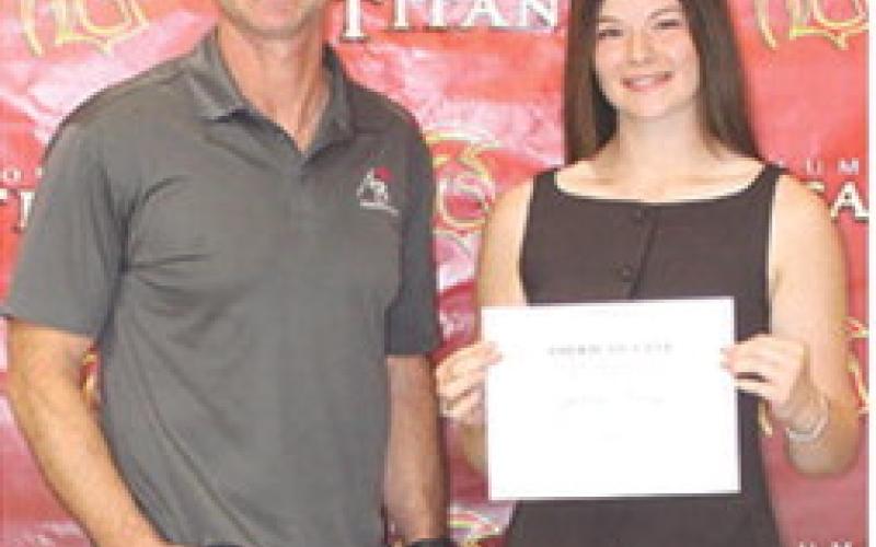 Senior Katelyn Draeger received the $1,000 American Bank Scholarship from Bank Executive, Jim Gaither, during the Columbus Unified High School Senior Assembly, May 15, at the gymnasium.