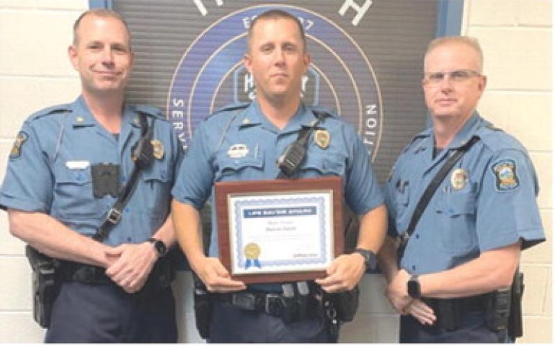 Ian Ingram presented the Life Saving certificate to Master Highway Patrol Trooper Dakota Smith as Captain Mark Drennan looks on. Courtesy photo.