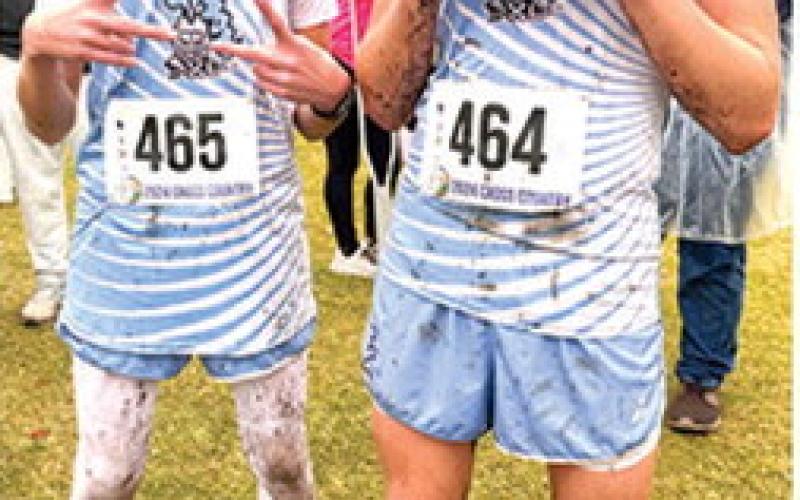Tucker Sutton, freshman, and Zane Gabern, were a little worse for the wear after finishing the Kansas Class 2A State Cross Country 5K Race, Saturday, at Rim Rock Ranch in Lawrence. Courtesy photo.
