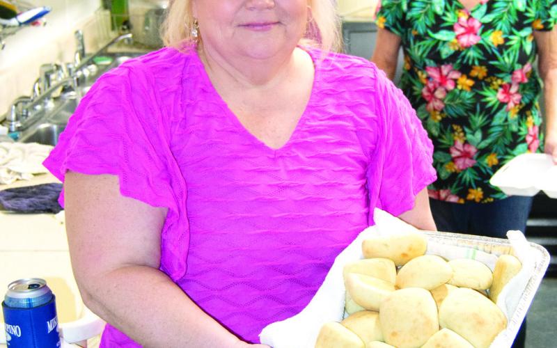 (Above) The West Mineral Eagles Lodge held a fund raising event for Ronald McDonald House. On the menu was chicken fried steak, potatoes and hot rolls. Delivering a basket of hot rolls from the kitchen was Janell Heath. At right Dayton Sims carried in bags of aluminum pop tabs from cans. Ronald McDonald House accepts the cans and tabs as a fund raiser for their good works.