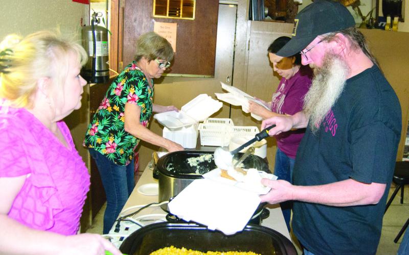 Janell Heath and Marcia Mallard serve the customers Anthony Swift and Beverly Lewellen. The fund raiser had a larger than expected turnout. The fundraiser was held for Ronald McDonald House. The group also took in a number of pop tabs for donation as well.
