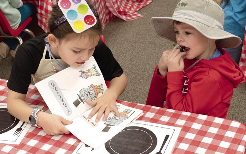 During Read Across America Week, Park Elementary students had a book tasting where they chose different styles of books to read. Baker Burns read to Maddox Grant from one of the books. News Report photo by Tanya Woolsey.