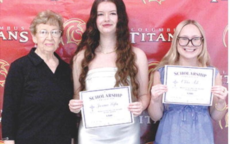 Jacianna Heflin and Chloe Ash, Columbus Unified High School Seniors, received $300 scholarships from the Mercy Columbus Auxiliary from Auxiliary Representative, Lucille McNemar, during the 2026 Senior Assembly, May 15, at the CUHS Gymnasium.