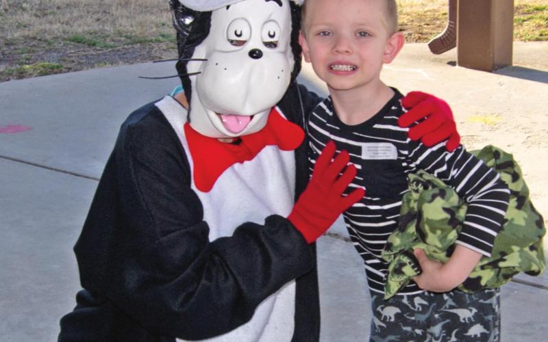 A special visitor came to greet Park Elementary students during the school’s Read Across America event last week. Nicolas McDonald stops to accept a hug from Dr. Seuss’s Cat in the Hat character on his way into the school. Photo Jacob Spencer.