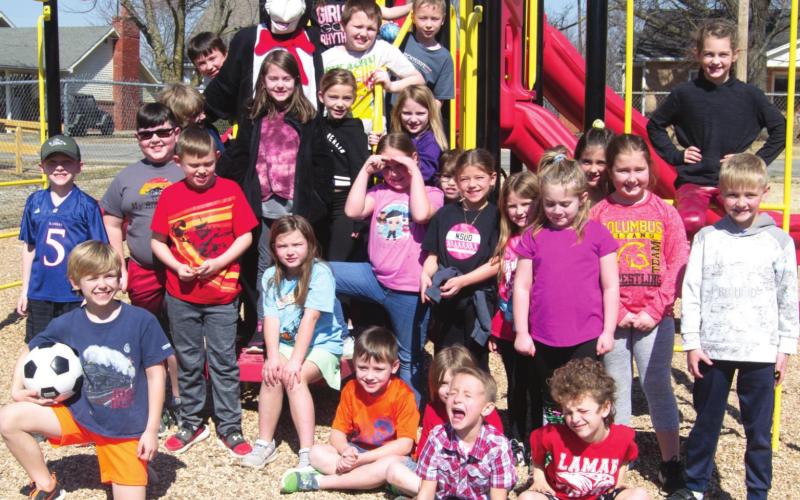 Highland Elementary students celebrated Dr. Seuss’s birthday through much of last week. A group of second grade students stopped playing during their recess to hang out with a surprise visitor, The Cat in the Hat on March 3. Photo by Jacob Spencer.