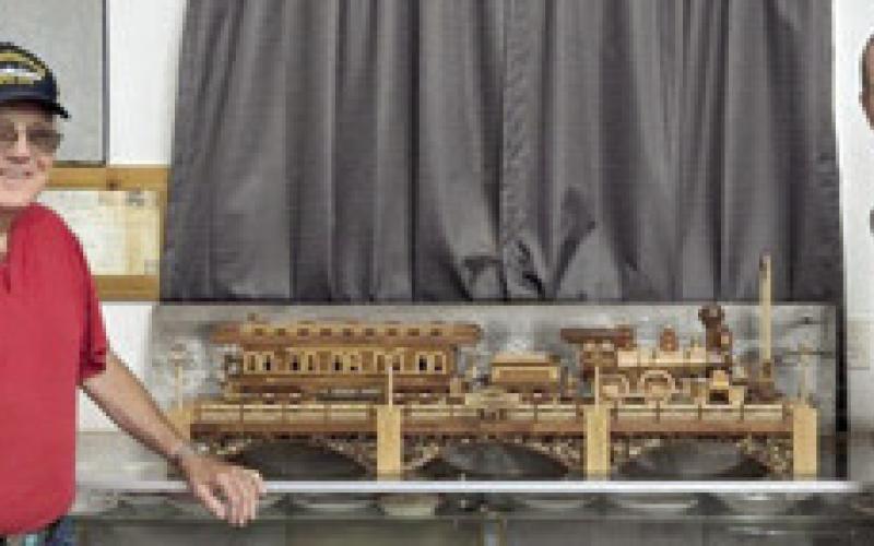 The Heart of the Heartlands Museum President Larry Spahn received the donation of a 1/24 scale wooden steam locomotive and coach car from Brian Troglia. Troglia said the train took him approximately 500 hours over four months to build. He used Cedar, Walnut, and Oak, all harvested and milled locally, to build it. Courtesy photo.