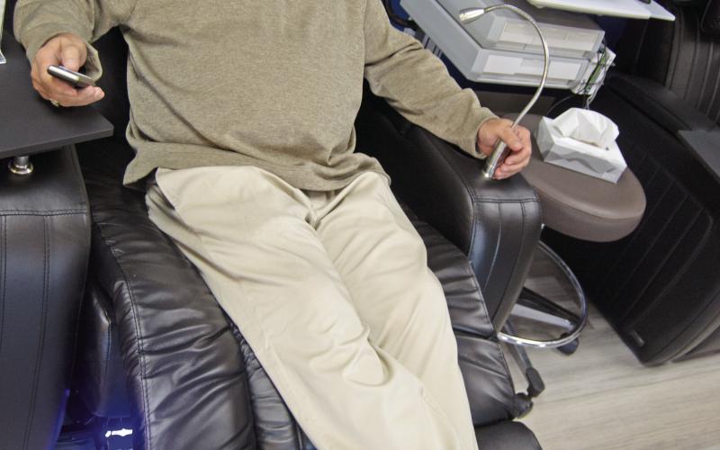 Steve Dunlap tests the comfort of the new Infusion Center reclining chairs. Patients may also choose heat or vibration while receiving infusion treatments.