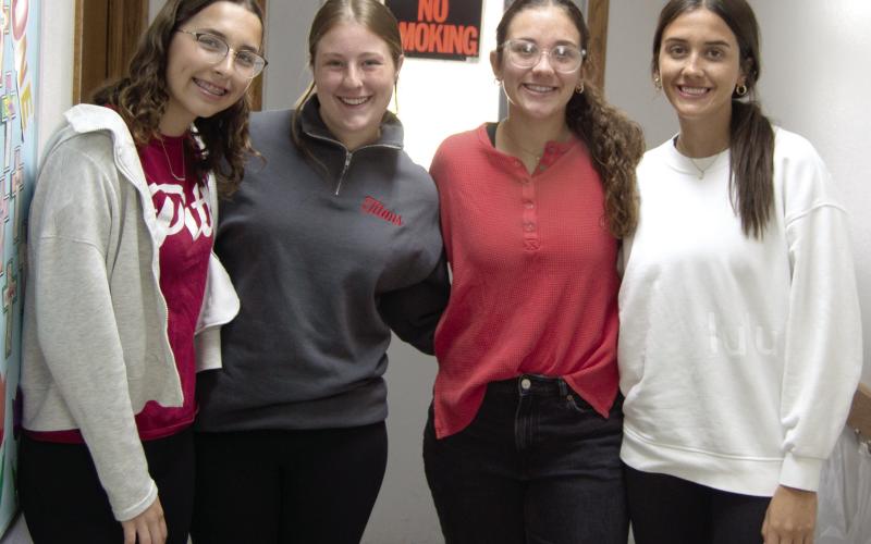 Torey Tedlock, Taryn Billings, Katy Mooney and Bryleigh Johnson were kept busy during the baked potato fundraiser put on by the Columbus PEO. Proceeds will be used to fund scholarships for young women to attend college.