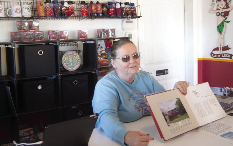 Renee Charles talks with visitors to the former gasoline station which has become a restaurant. Visitors can get a complete history of the 13.1 stretch of Route 66 through Kansas.