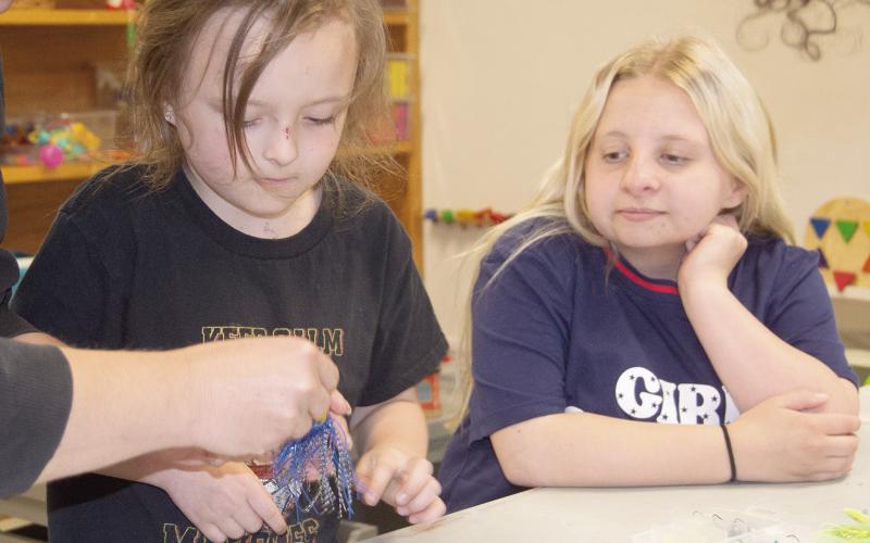 Columbus Public Library recently held a tackle box workshop for kids. Chiildren were able to build their own tackle boxes. Adaline Jameson and Layla Stewart enjoyed adding lures to their boxes during the event. News Report photo by Tanya Woolsey.