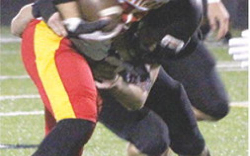 Titan Senior, Syler Schuberger, collects some of his 114 total yards against a tough Prairie View Defense in the Kansas Class 3A Regional loss, 13-34, Friday in LaCygne.