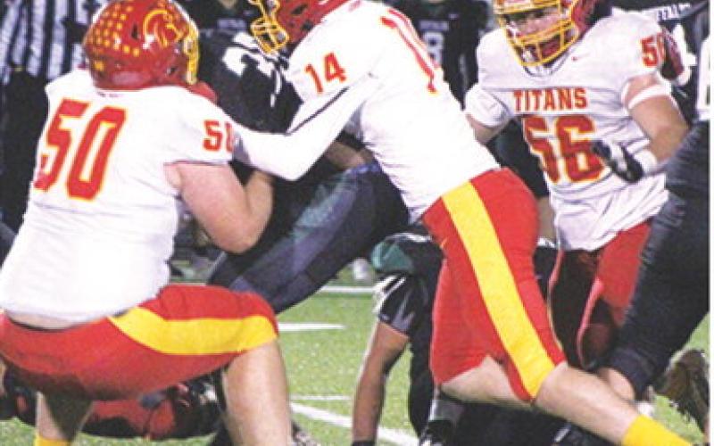 Titan Seniors, Carter Henry and Brandon Stice tackle Buffalo Runningback, Josh Goodwin, junior, in the Prairie View backfield as freshman, Kash Smith, moves in to assist in the 13-24, Columbus loss to Prairie View in LaCygne, Friday. The Titans end their season with a 7-3 record in the Kansas Class 3A Regional game following a 2-7, 2023 season.