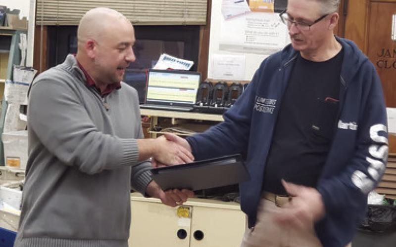 Columbus Post Master Tyler Speer presented long time postal carrier Martin White with a certificate recognizing his years of service and celebrating his retirement. White began in 1997 as a temporary substitute rural carrier. White has spent his entire career in Columbus. Courtesy photo.