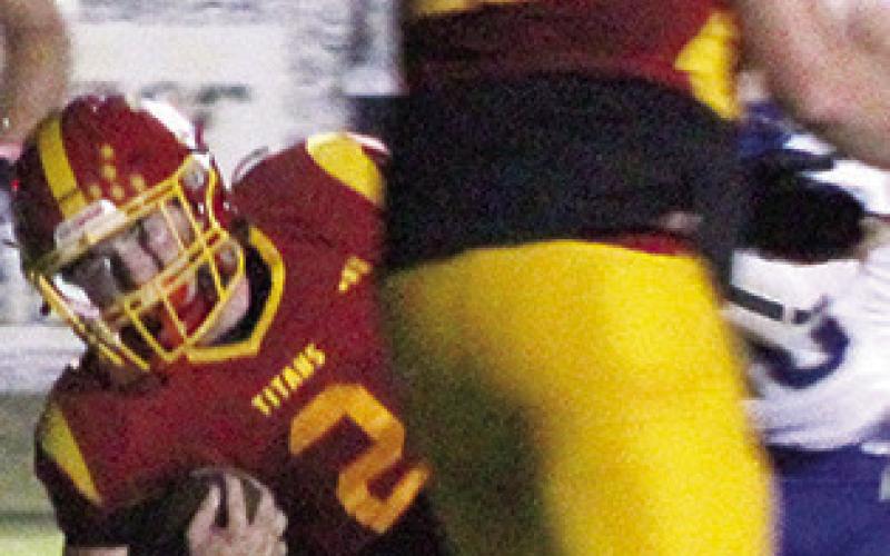 Jett Tanner, Titan Senior, dives across the goal line for the Titans first touchdown of the game from six yards out to cut Riverton’s lead, 6-7, in the first quarter of the Ram win, 21-12, Friday in Columbus.