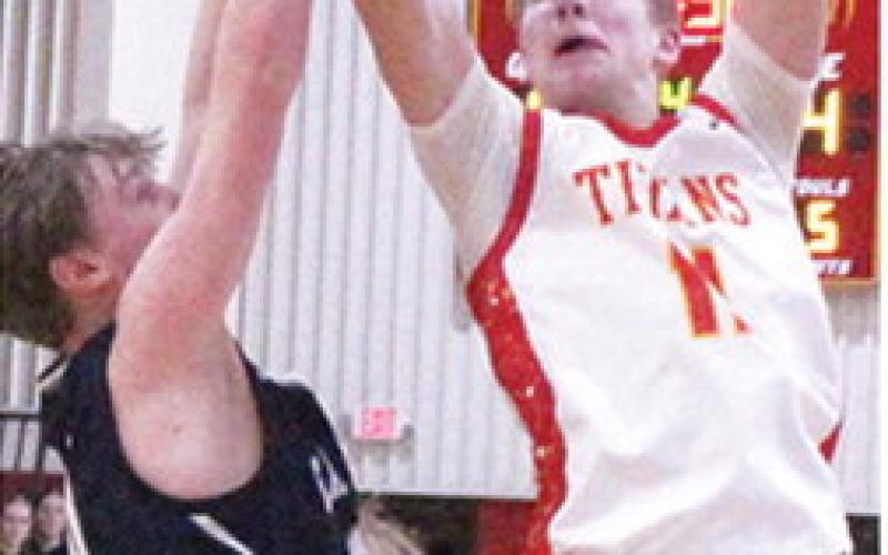 Titan Sophomore, Jonas Stover, goes up for the goahead basket with 1:32 on the game clock. Jonas made the and-one free throw for a two-point, 47-45, lead in the 50-47 win over Galena, Thursday at the CUHS Gymnasium.