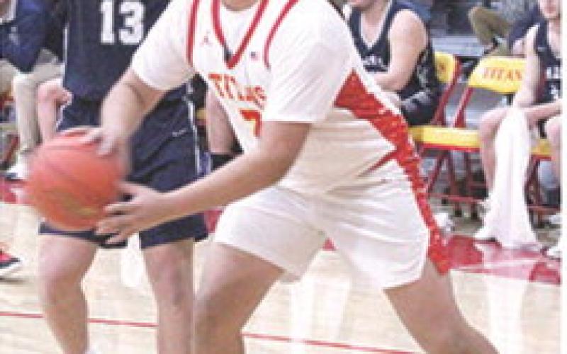 Titan Senior, Rece Ponce, passes around Galena defender, Evan Wittenmyer, junior, in the 68-45, Bulldog win at Columbus on Senior Night, Friday. The Titans and Bulldogs will meet again, Friday, in the Kansas Class 3A Regional at Galena.