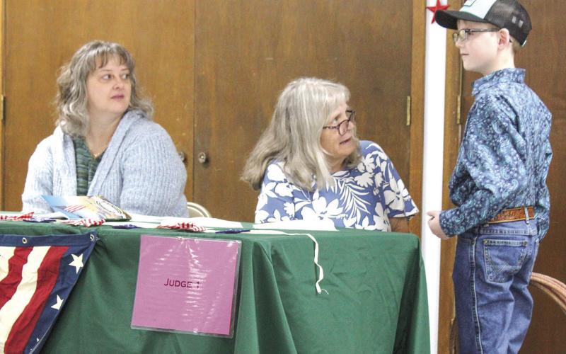 At the annual 4-H Style Revue held Saturday, June 27 at the Extension office in Columbus, Ezra Vanderbeck showed his outfit to the judges and answered questions posed to him.