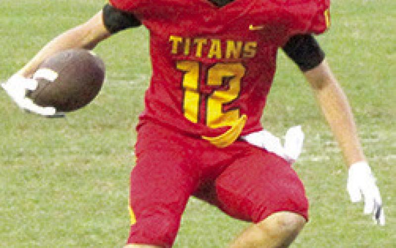Freshman, Cole Howard, jukes, his defender to gain yardage in the Columbus JV loss to Colgan, Monday, at Titan Stadium. Complete story on page nine.