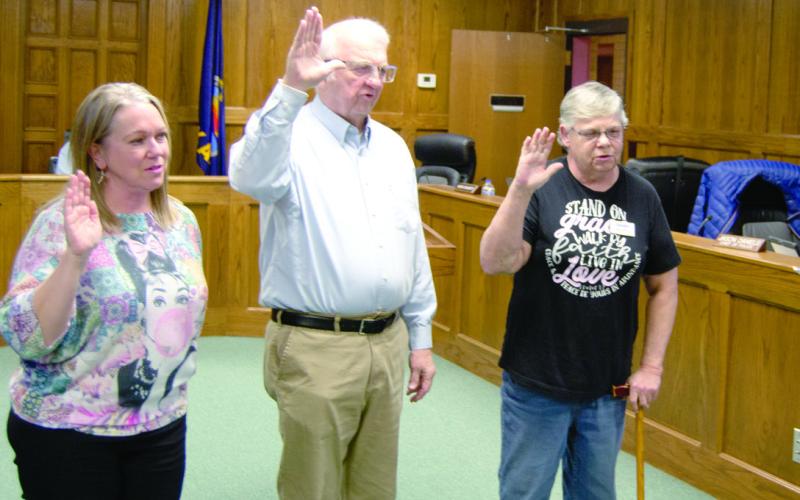 Newly elected Columbus City Council member Laura Epler (left) was sworn into to her Ward 1 position on Tuesday evening by City Clerk Ruth Hutley. Former City Council members Tom Pryor and Kathy Doherty were also sworn in by Hutley as they returned to office.