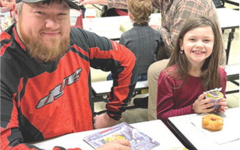 Ryan Clark joined Summer Clark at Park Elementary recently for their Books and Breakfast event. Friends, family members and older students joined the elementary classes to read a book or two and have breakfast. Courtesy photo.