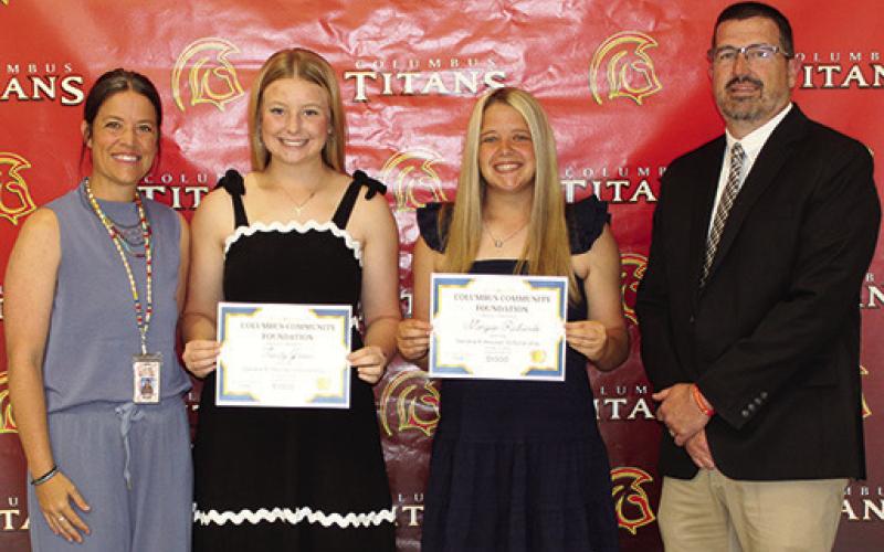 Trinity Green and Morgan Richards received the Sandra B. Houser Memorial Scholarship in the amount of $1,000 each from CACF Board Member, Kelly Walters and USD 493 Superintendent Dan Grundy during the Senior Assembly, May 15, at the Columbus Unified High School Gymnasium.