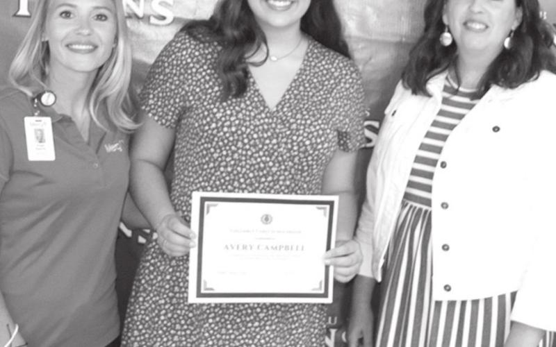 Angie Saporito and Jennifer Thompson presented Avery with the Columbus Cares Scholarship.