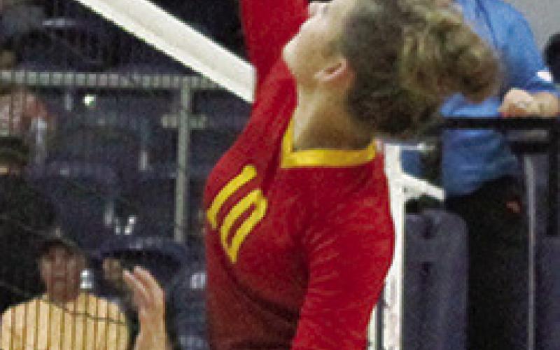 Ruby Stover swings for one of her team-high, six kills for the Lady Titans, Tuesday in Galena. The senior middle hitter also had four digs and three blocks.