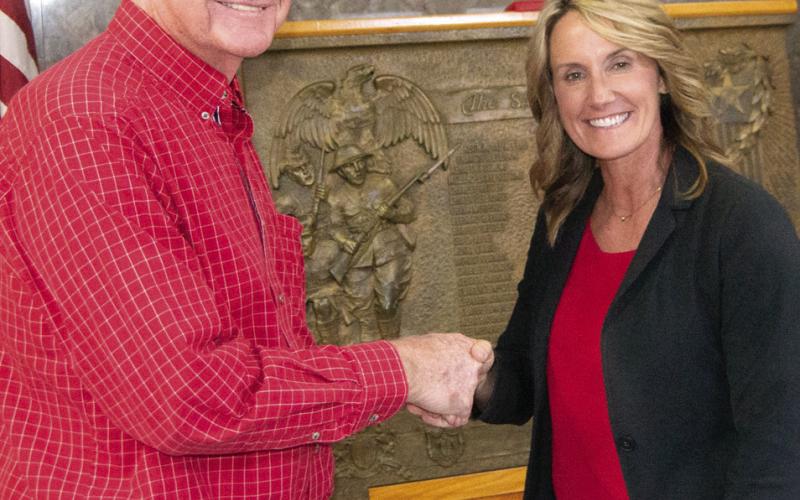 Newly elected District 2 Commissioner Jack Garner is congratulated by outgoing commissioner Lorie Johnson. Johnson did not run for office this term.