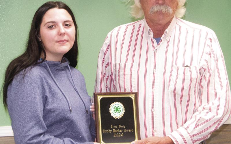 Airaunana Sharp presented the annual 4-H Buddy Baker Award to Jerry Seely. This award goes to someone who has taken an active role in supporting 4-H and the Cherokee County Fair in the last few years. He is an active bidder at the dessert auction and has sponsored awards.
