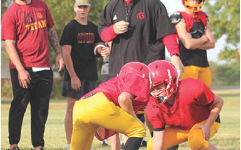 Titan Head Coach Blake Burns, assistant coach Brett Hamilton and Titan players oversee drills ran by the Mini Titans during the annual Lawn Chair Scrimmage, Saturday at the Central School Soccer Field.