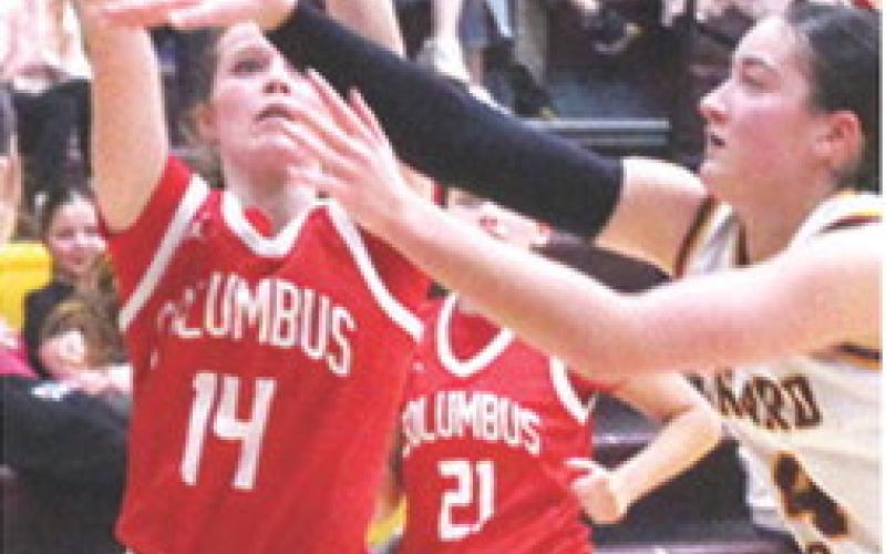 Lady Titan Junior, Bentley Townsend, shoots among the arms of many defenders in the Columbus loss to Girard, 26-67, Tuesday in Girard. Bentley led the Lady Titan scoring with eight points.