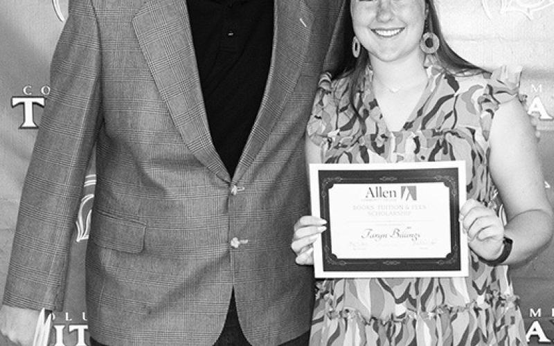 Lady Titan Senior, Taryn Billings received a $9,000 Allen County Community College for tuition, fees, and books from CUHS Instructor, Matt Crain, during the Columbus Unified High School Senior Awards Ceremony at the high school gymnasium, May 17.