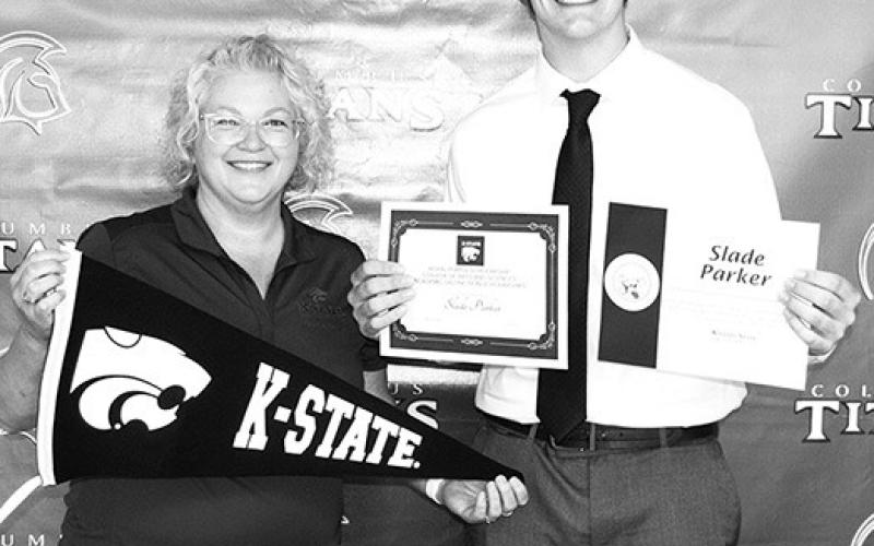 Senior, Slade Parker, received two scholarships from Kansas State University from Rhonda Herrenbruck, KSU Representative at the Columbus Unified High School Senior Awards Ceremony, May 17, at the CUHS Gymnasium. Slade received a $16,000 Royal Purple Scholarship and a $3,000 College of Arts and Sciences Academic Scholarship,