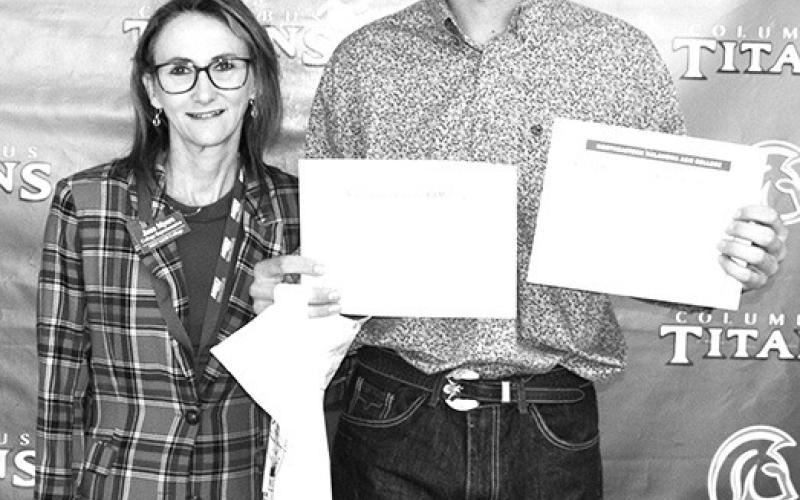 Titan Senior, Cole Youngblood received a pair of scholarships from Northeast Oklahoma A&amp;amp;M College from Jana Myers, NEO Representative. The Viking Tuition Scholarship for $600 and the NEO Foundation Scholarship for $1,500 were presented during the Senior Awards Ceremony, May 17, at the Columbus Unified High School Gymnasium.