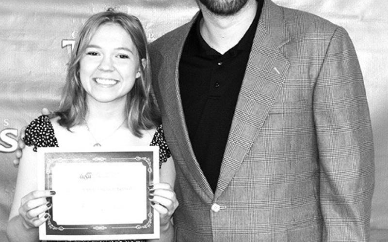 Senior, Bethany Johnson, received a $12,000 Wichita State University, Wichita Merit Scholarship from CUHS Instructor, Matt Crain, during the Columbus Unified High School Senior Awards Ceremony, May 17 at the high school gymnasium.