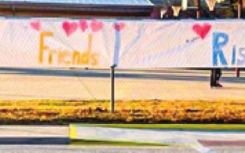 A banner that read, “Thankful Friends Rise” made by Columbus Central fourth grade classrooms hung on the fence across the street from the RISE Center Tuesday morning. One of the center’s Speech Pathologists, Jennifer Thompson, later said, “The partnership with the Columbus School District has helped the RISE Center to thrive. We’re so thankful for the relationships and friendships between us and Central.” Photo by Jacob Spencer