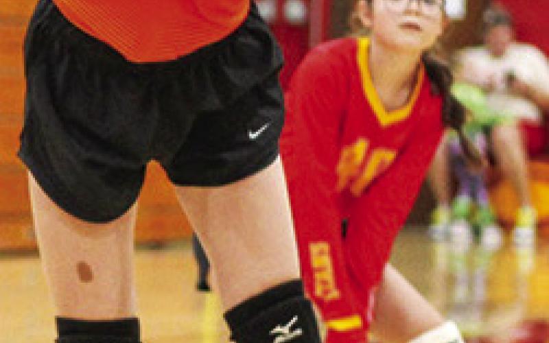 Seventh Grader, Kensley Blackledge, returns a hit during recent Columbus matches at the CUHS Gymnasium. Awaiting the result is Madison Duling in the background.