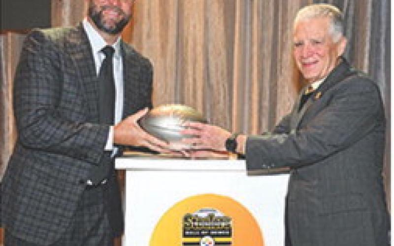 Ben Roethlisberger receives his commemorative football from Steelers President Art Rooney II upon his selection into the Steelers Hall of Honor Class of 2025. Roethlisberber joins linebacker, Joey Porter Sr. and center, Maurkice Pouncey. The ceremony took place over the weekend at Acrisure Stadium in Pittsburg. Courtesy photo Steelers.com.