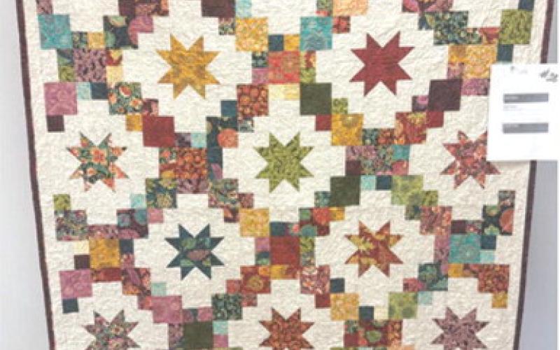 First place in the Columbus Day quilt show went to Becky Shearburn for her entry called “Brightly”.