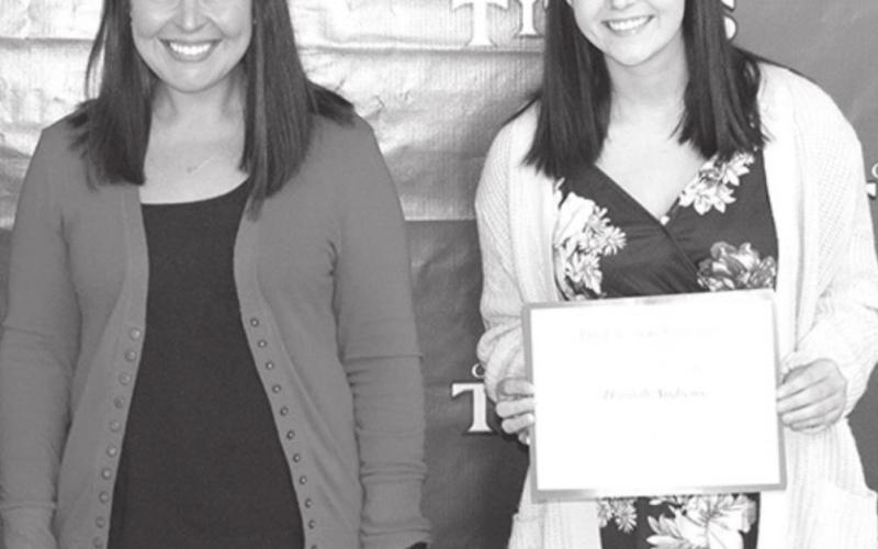 Hannah Andrews received the Pittsburg State University Alumni Legacy License Plate Scholarship in the amount of $500 from Meagan Swafford, Pittsburg State University representative at the Senior Awards Assembly in the CUHS Gymnasium, May 14.