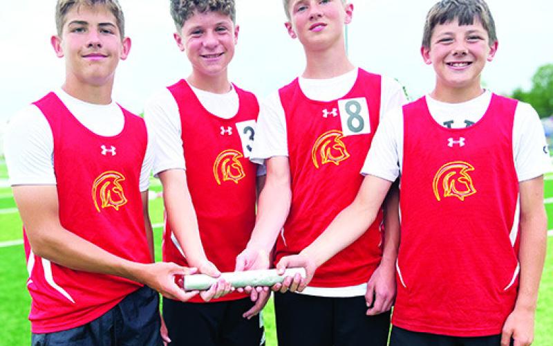 The Columbus Titan Seventh Grade 4x800 Meter Relay Team set a new school record at the Girard Invitational Track and Field Meet, April 17. Team members Blaze Bowman, Evan Walters, Eli Engleman, Cam Carter completed the race with a time of 11:13.7 minutes beating the 2002 record of 11:38 minutes set by Chet Mercer, Cory Burton, Chris Wells, and Cody Morris. Courtesy photo.