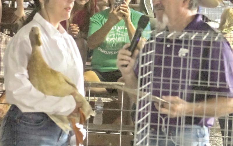 During the poultry show at the 2025 Cherokee County Fair, Airauna Sharp spoke with the judge about her duck. Results were announced and ribbons issued in both the Open Class as well as the 4-H, FFA and Heritage Youth Association class. Photo by Jadeyn Ivey.