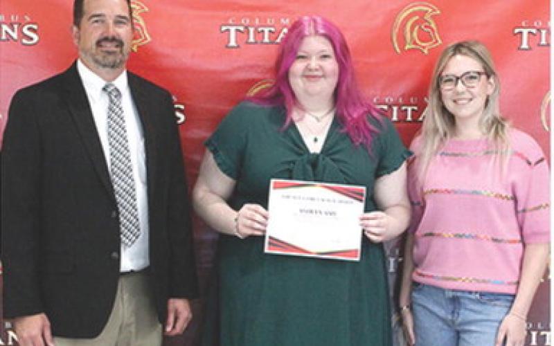 Ashlyn Ash received the Grundy Family Scholarship in the amount of $500 from new USD 493 Superintendent, Dan Grundy and his daughter and 2024 CUHS Graduate, Reese Grundy, during the 2025 Senior Assembly, May 16, at the Columbus Unified High School Gymnasium.