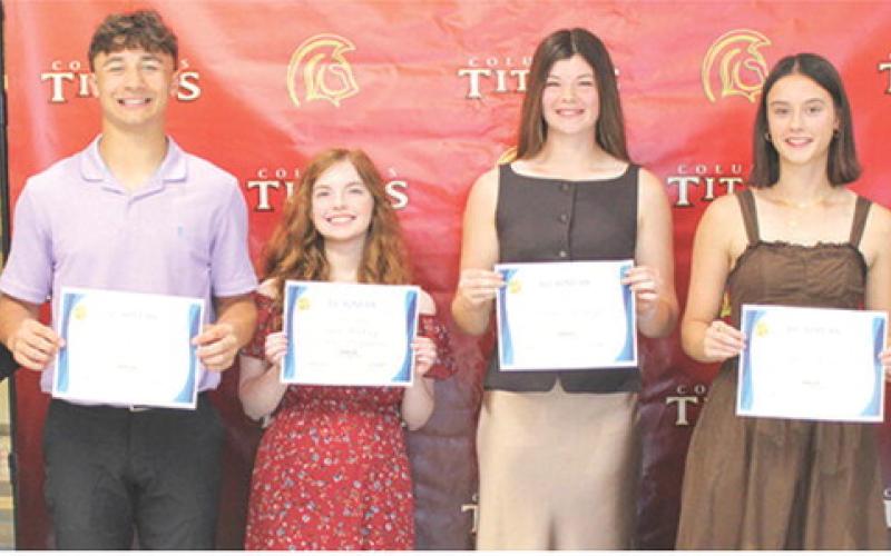 Titan Seniors Jayden Rodriguez, Ava Hulvey, Katelyn Draeger, Piper Hayes, and Lemmie Stone each received a $300 CJSHS Business Scholarship from Instructor Laura Boeckman during the Columbus Unified High School Senior Awards Assembly, May 15, in the high school gymnasium.